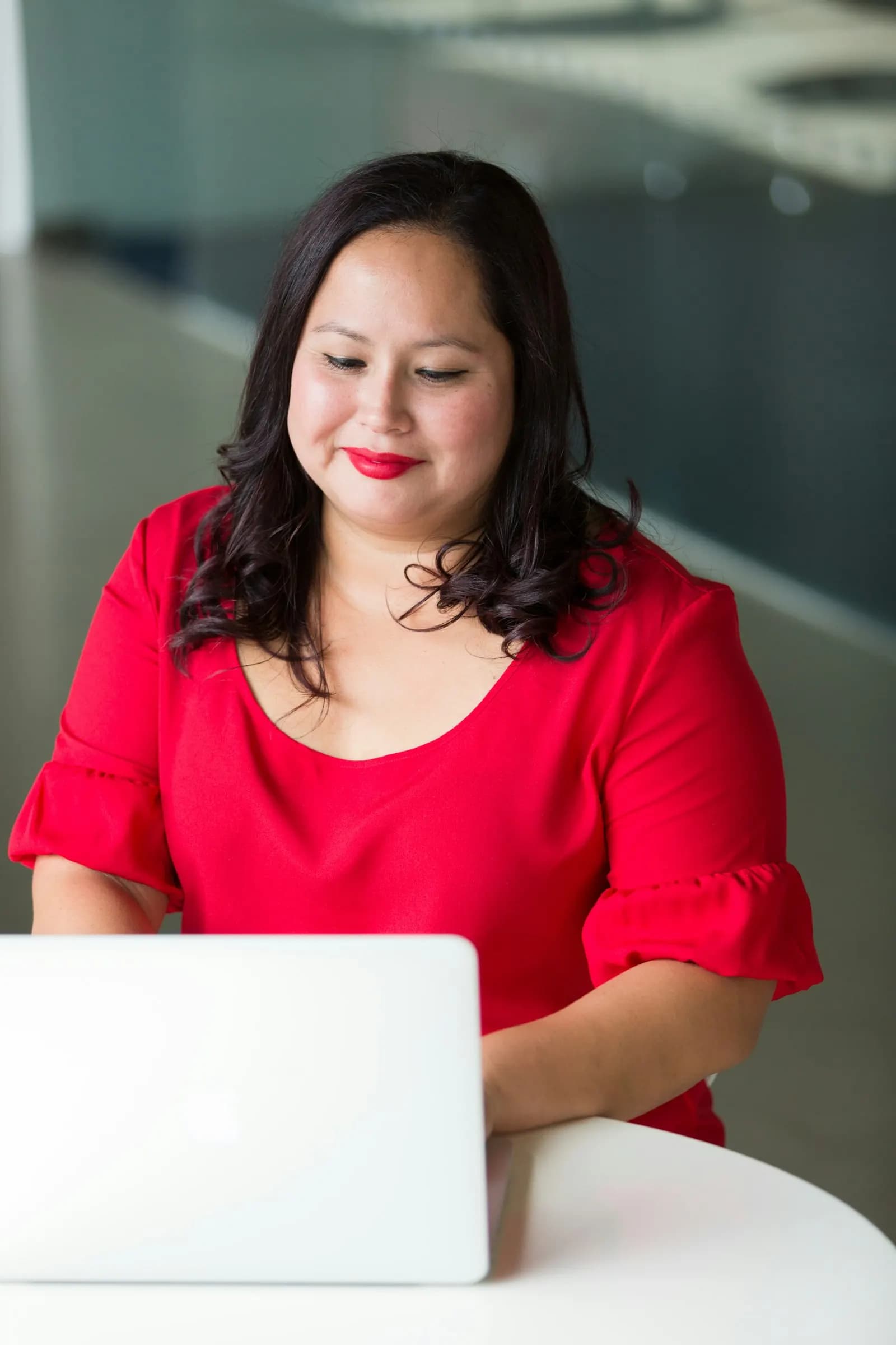 A developer smiling at her laptop